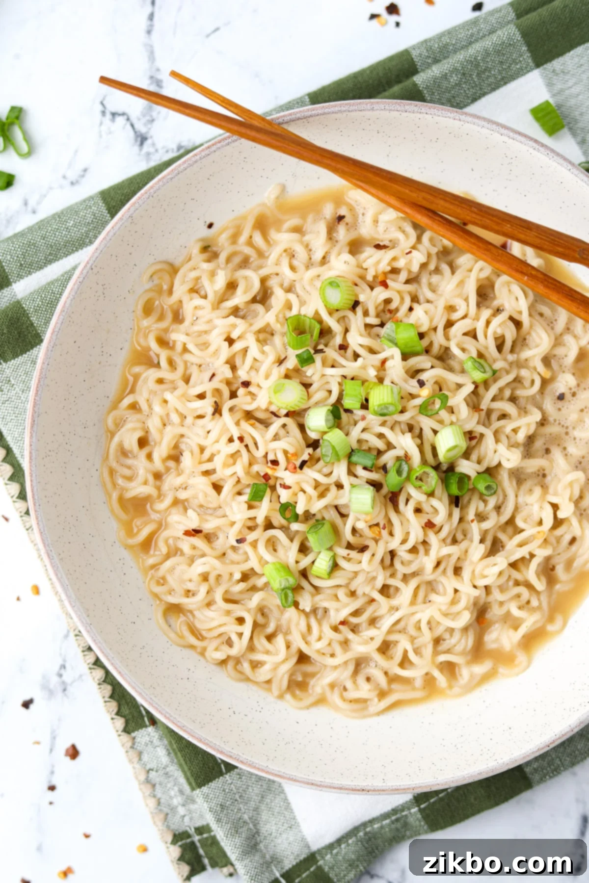 Kylie Jenner's Viral Ramen Hack 2 A bowl of ramen garnished with red pepper flakes and green onion.