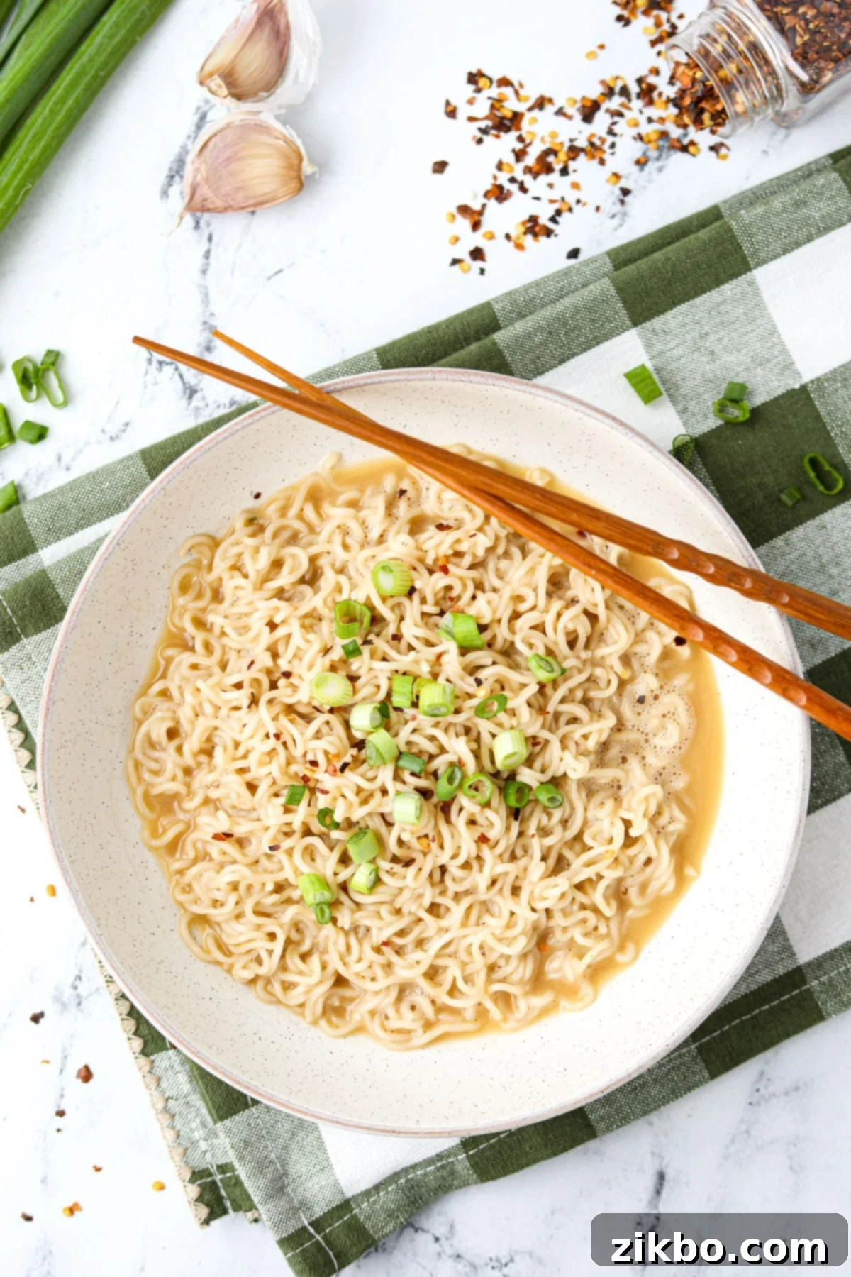 Kylie Jenner's Viral Ramen Hack 7 A bowl filled with ramen, with chopsticks on the side.