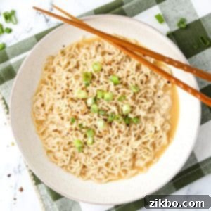 Kylie Jenner's Viral Ramen Hack 9 An overhead shot of a bowl of ramen, garnished with green onions and served with chopsticks.