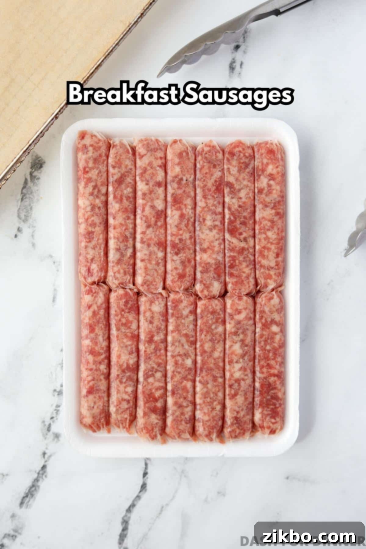A styrofoam container filled with raw breakfast sausages, ready for cooking.