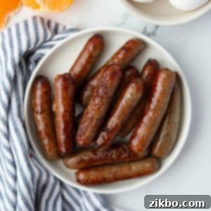 A small plate filled with cooked breakfast sausages, perfectly browned and ready to eat.