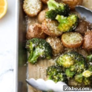 Crispy Roasted Broccoli and Potatoes 10 A close up of a pan of roasted broccoli and potatoes, showing the golden potatoes and vibrant green broccoli with crispy edges.