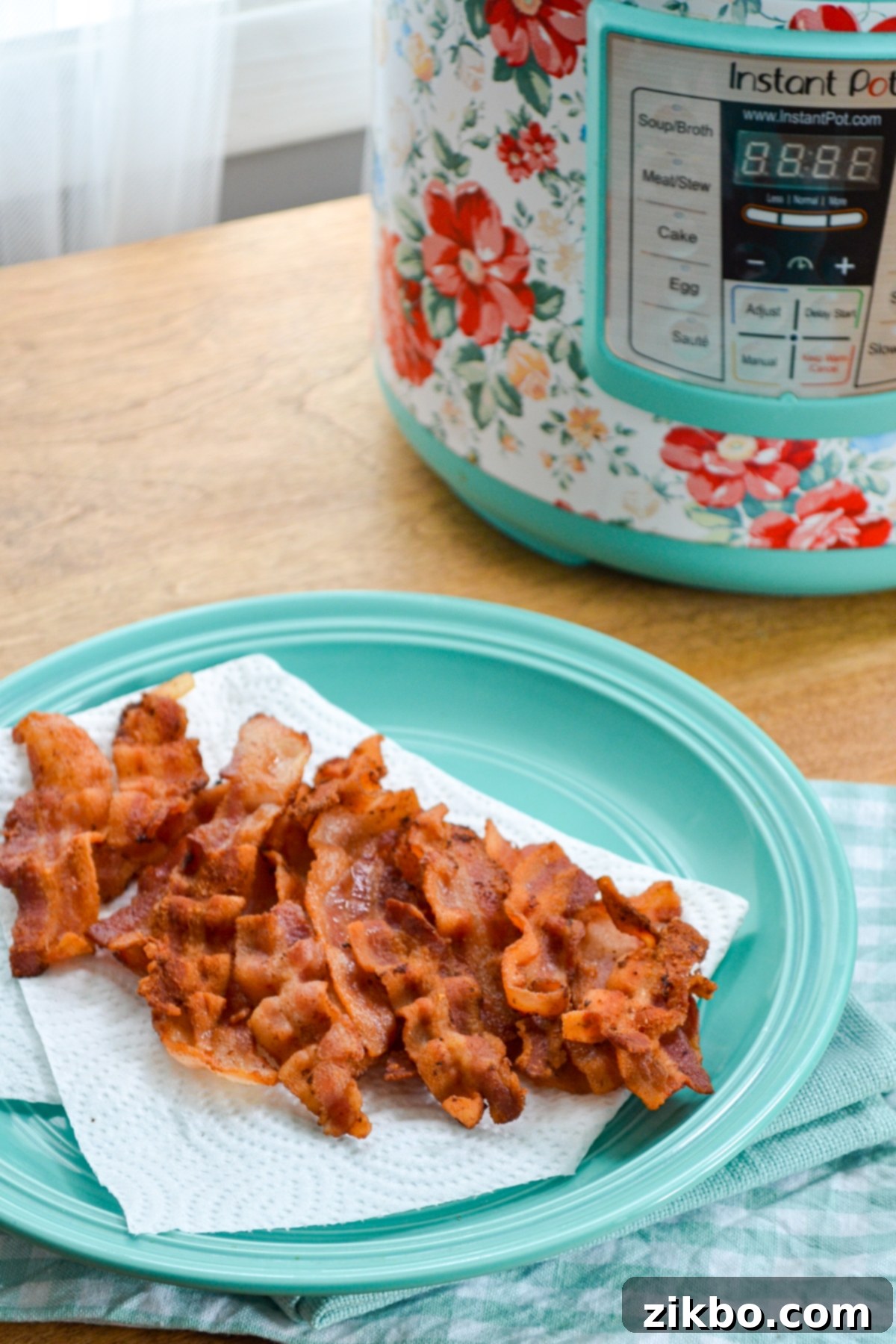 Cooked sliced and crispy bacon using the Instant Pot, presented on a plate.