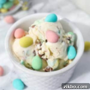 Pastel Egg Crunch Ice Cream 10 A white bowl filled with creamy no-churn Mini Egg Ice Cream, generously dotted with colorful Cadbury Mini Eggs, showcasing a delightful Easter dessert.