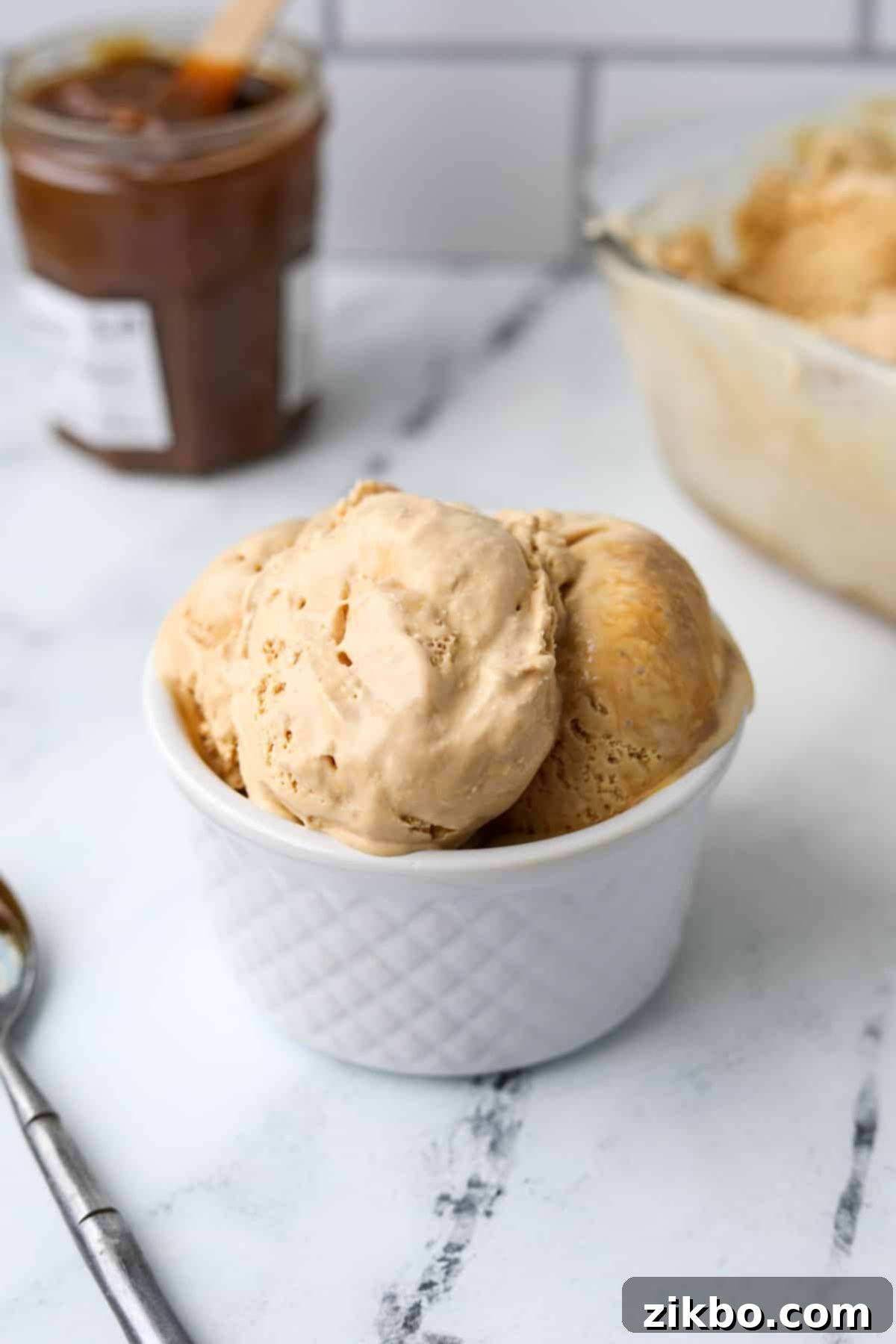 Decadent Dulce de Leche Ice Cream 9 A small dish filled with beautifully scooped homemade dulce de leche ice cream, ready to serve.