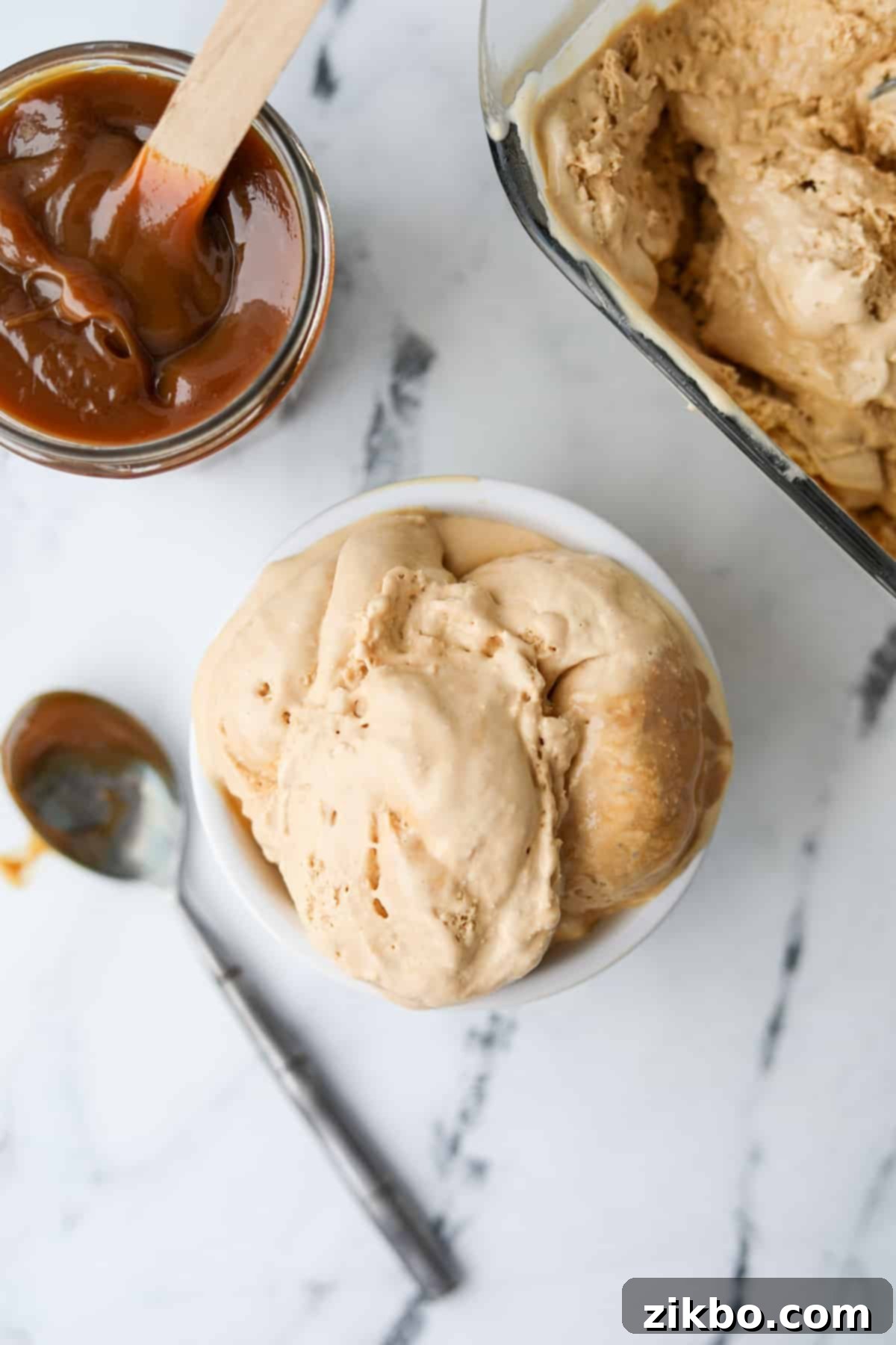 Decadent Dulce de Leche Ice Cream 10 An overhead shot of a small dish filled with creamy dulce de leche ice cream, showing its smooth texture.