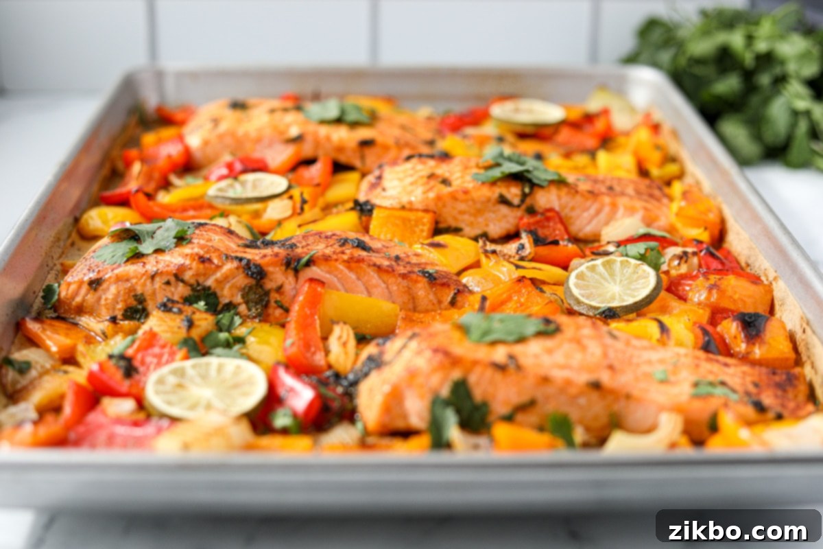 A sheet pan filled with vibrant, colorful bell peppers and onions, roasted to perfection, showcasing the delicious side dish potential.