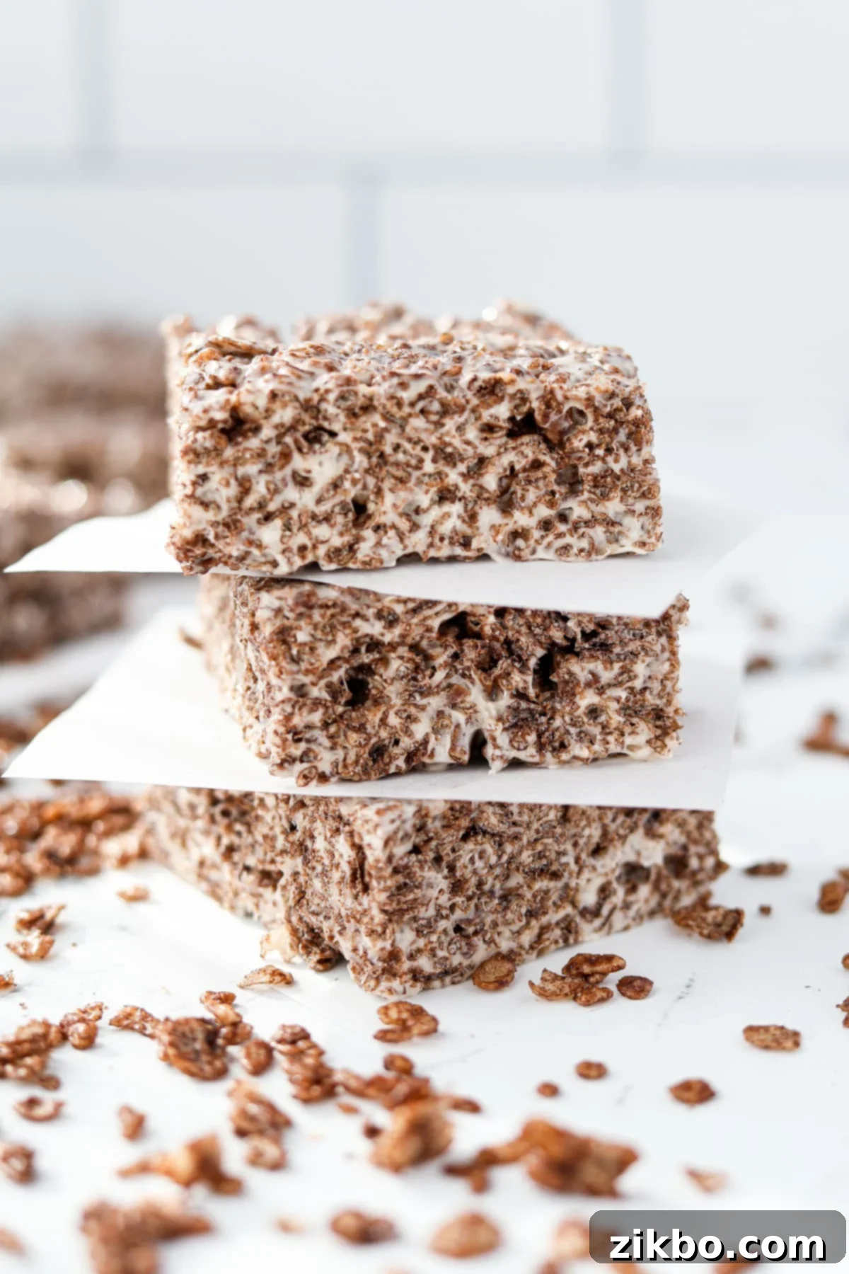 A layer of three cocoa pebbles cereal treats.