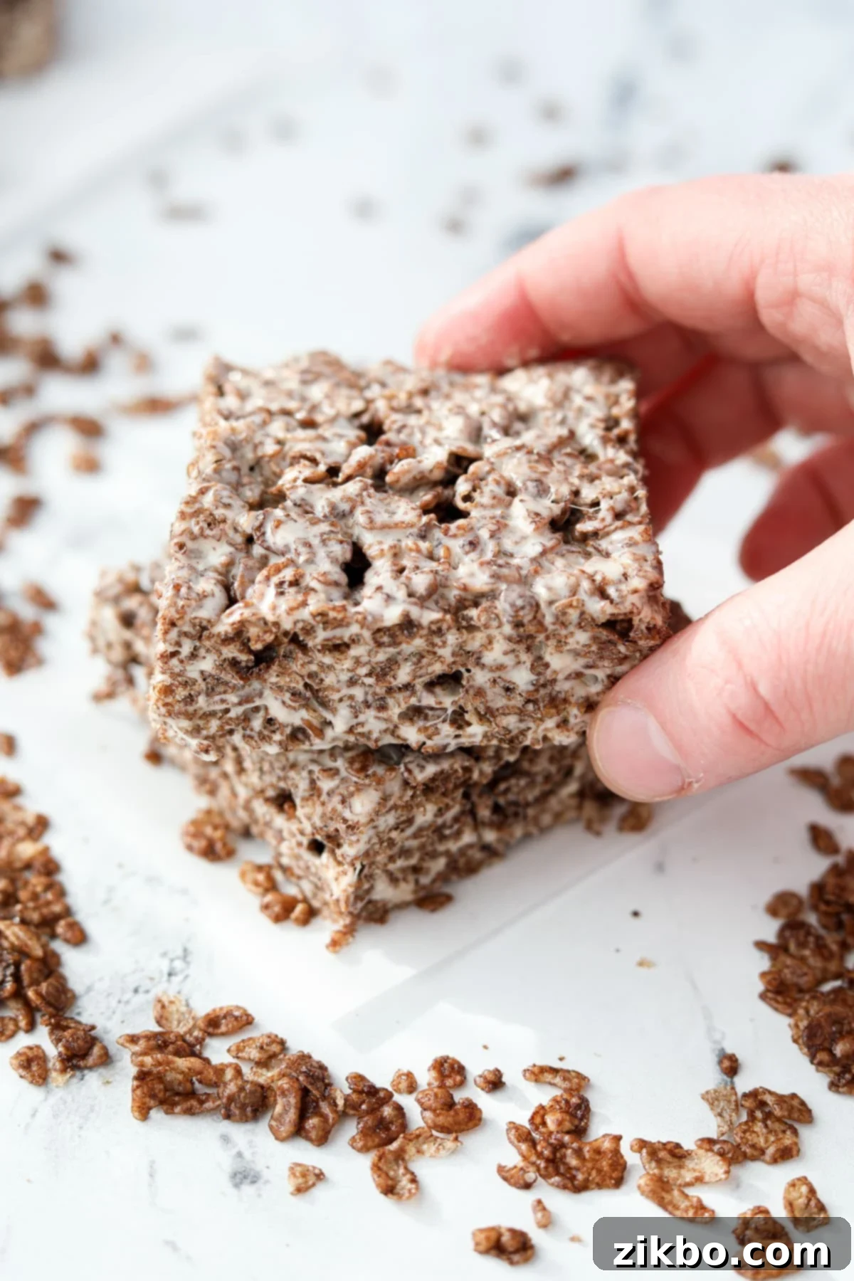 Setting a cereal treat on top of another one.