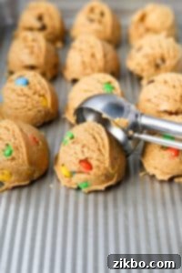 Scooping cookie dough onto a baking sheet.