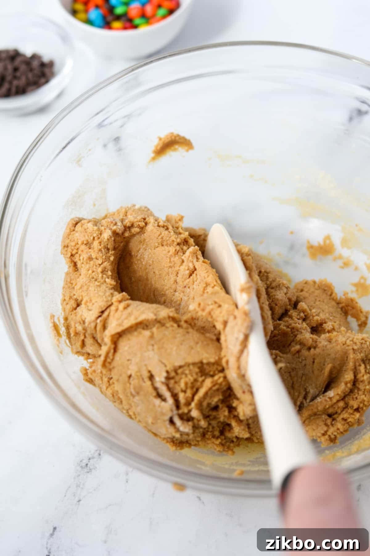 Protein Cookie Dough 5 A smooth, light brown protein cookie dough mixture in a bowl after being thoroughly stirred.