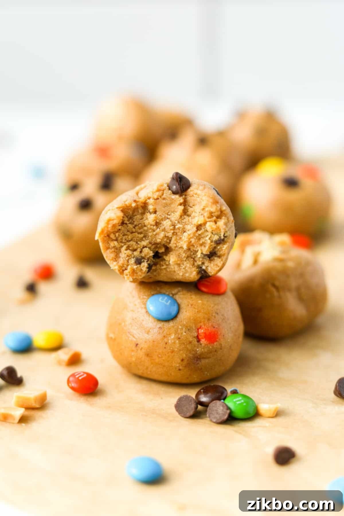 A stack of two protein balls with m&m's and chocolate chips.
