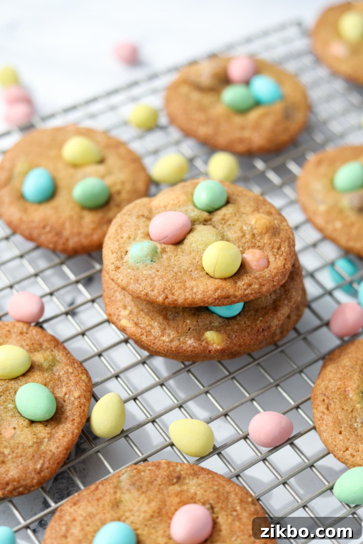 Homemade cookies on a wire rack, topped with Cadbury mini eggs.