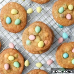 Homemade cookies on a wire rack, studded with Cadbury mini eggs.