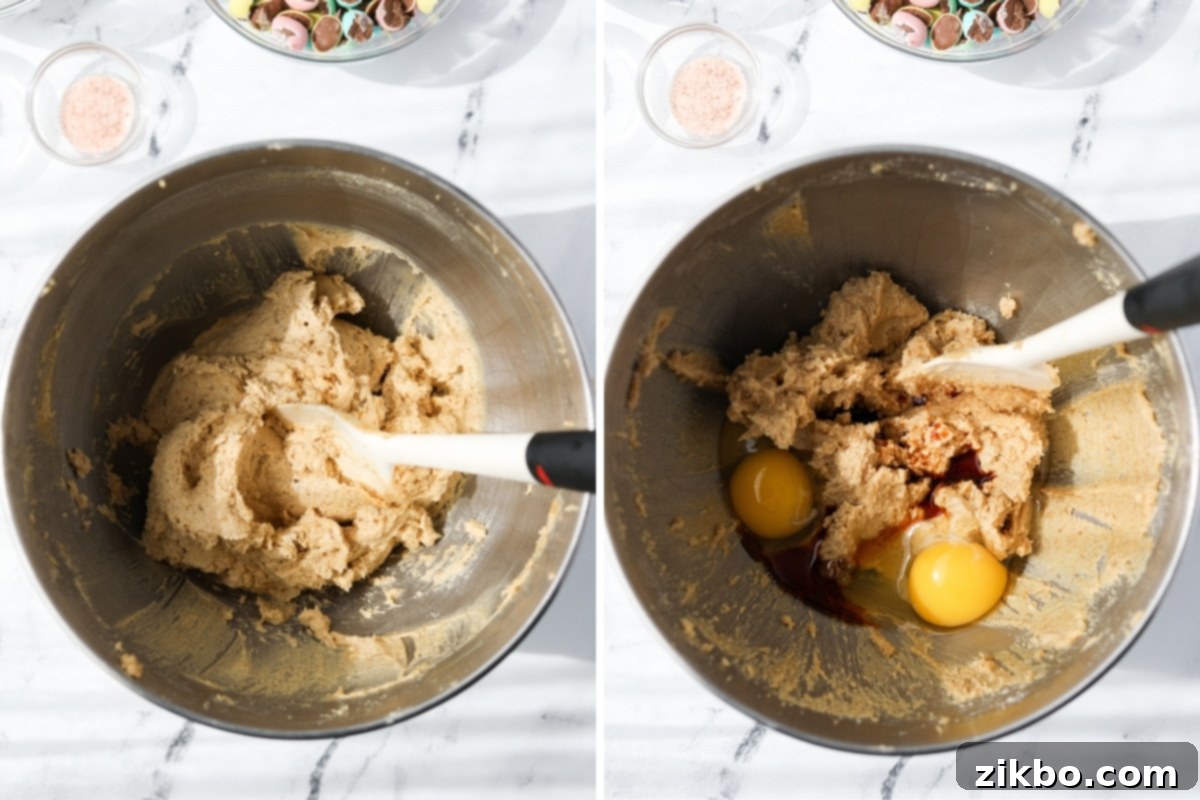 A stand mixer bowl with cookie dough, eggs, and vanilla in it.