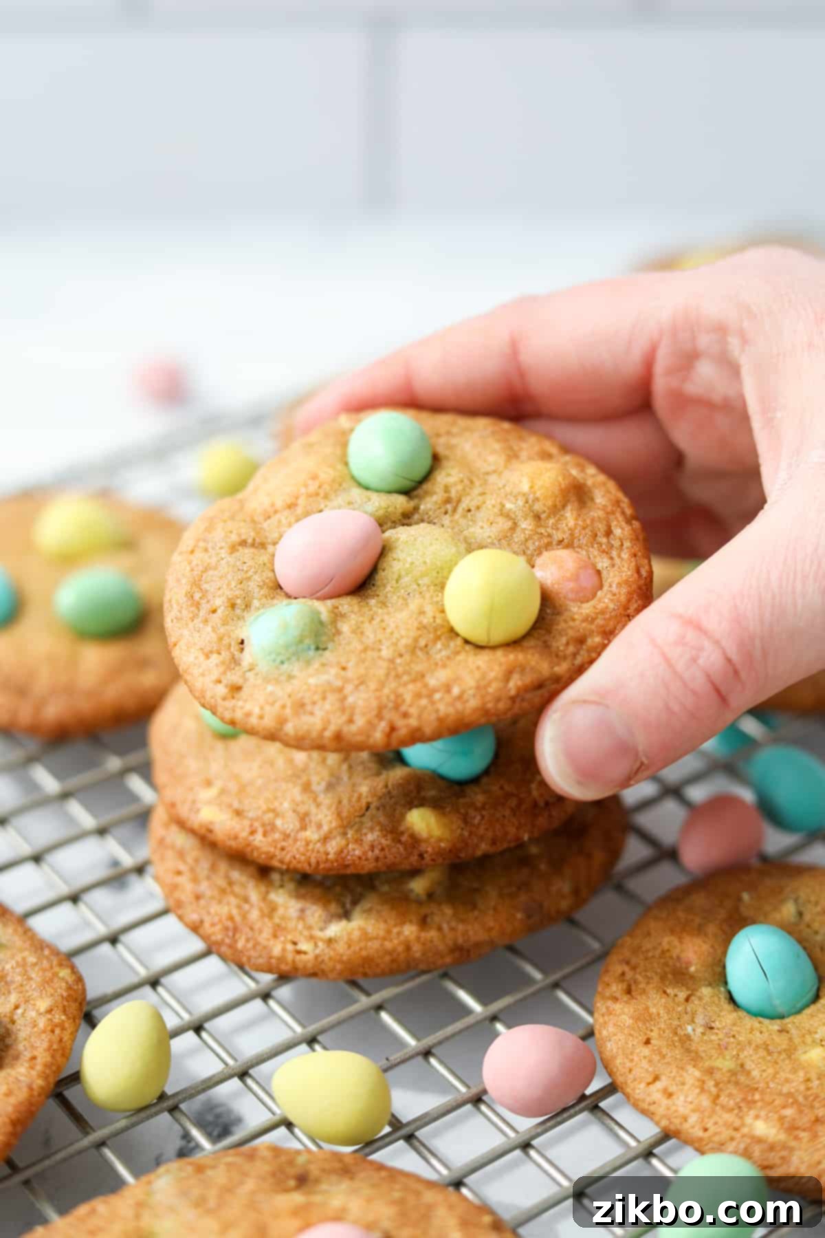 Stacking cookies that are covered with Easter eggs.