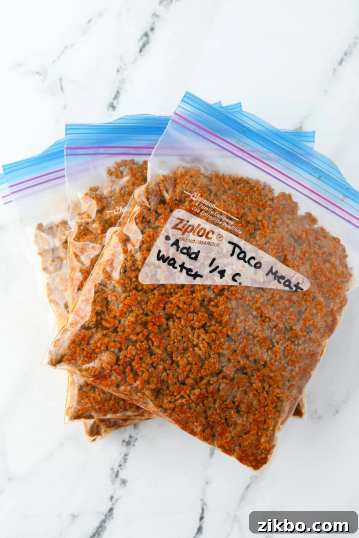 Three freezer bags filled with perfectly seasoned ground beef taco meat, ready for the freezer.