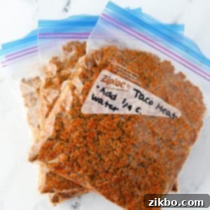Three freezer bags filled with delicious taco meat, clearly labeled and flattened for efficient freezer storage.