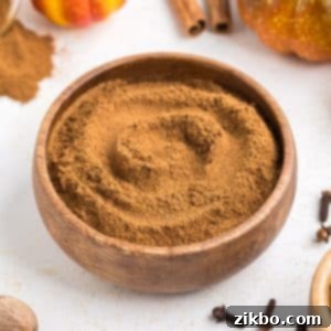A small wooden bowl of homemade pumpkin spice, ready for use.
