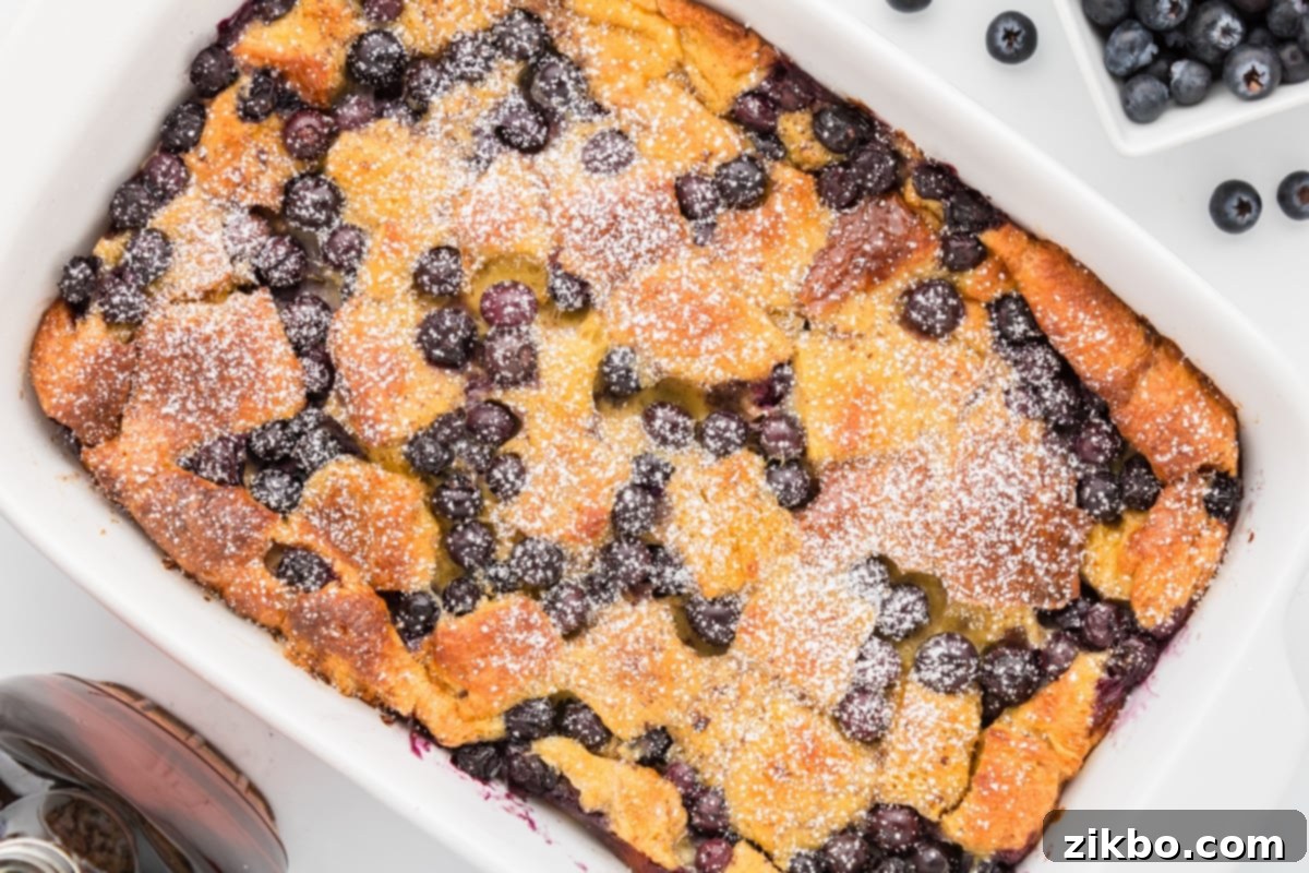 Overnight Brioche French Toast Bake 12 A French toast casserole garnished with blueberries and powdered sugar.