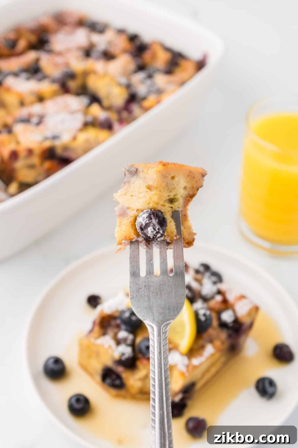 Overnight Brioche French Toast Bake 14 A fork with a piece of French toast on it.