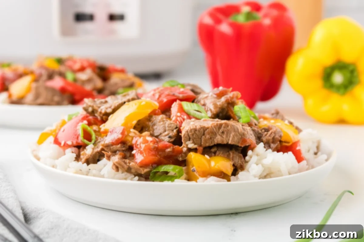 Slow Cooker Pepper Steak 15 A bowl with peppers and beef, ready to be served.