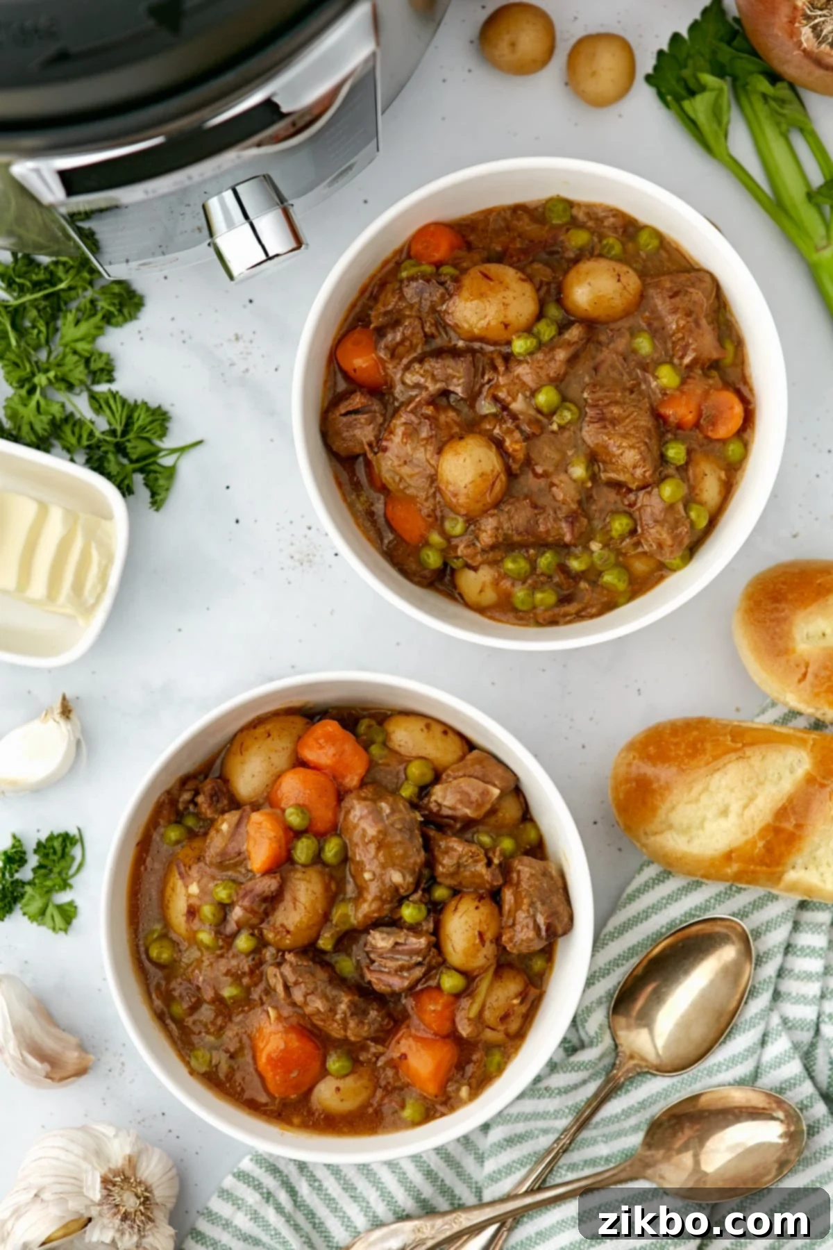 Two bowls of beef stew on a countertop.