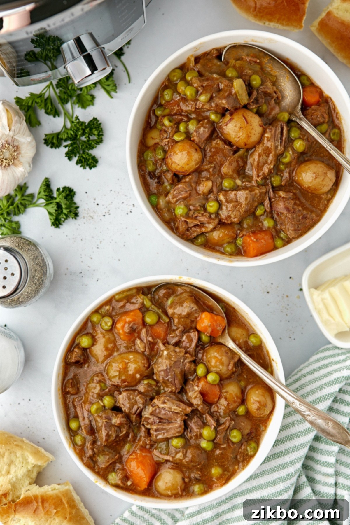 Two bowls of beef stew on a countertop.