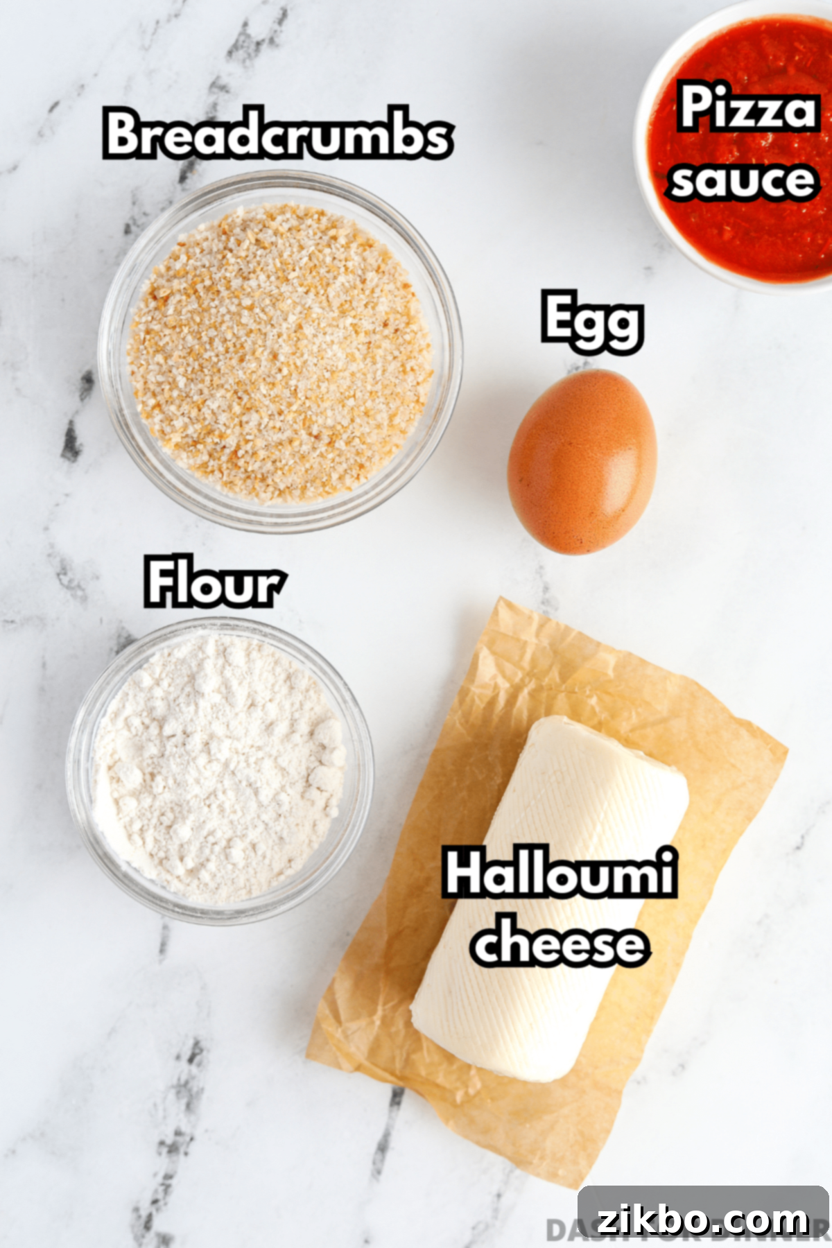 Ingredients needed to make air fryer cheese fries: halloumi, breadcrumbs, flour, egg, and pizza sauce arranged on a white background.