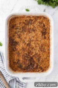 A baking dish filled with cooked rice and onions.