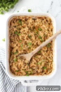 A baking dish filled with rice and garnished with parsley.
