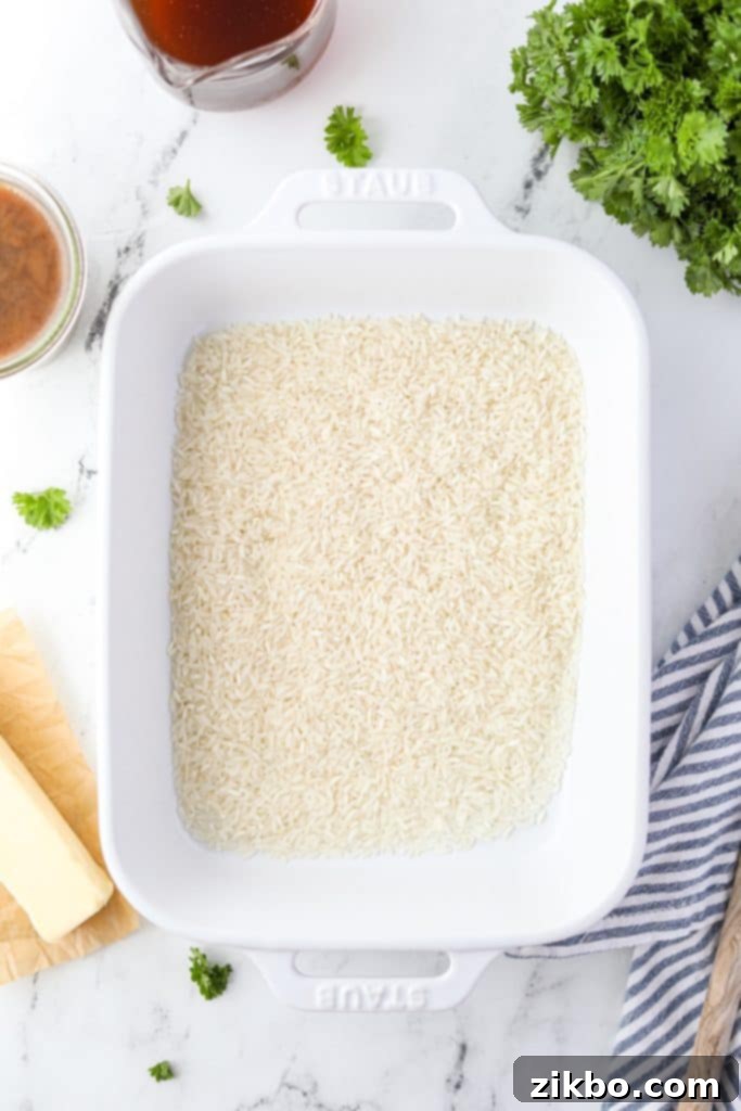 Golden Butter Rice 4 A baking dish with 1 cup of long-grain rice spread out.