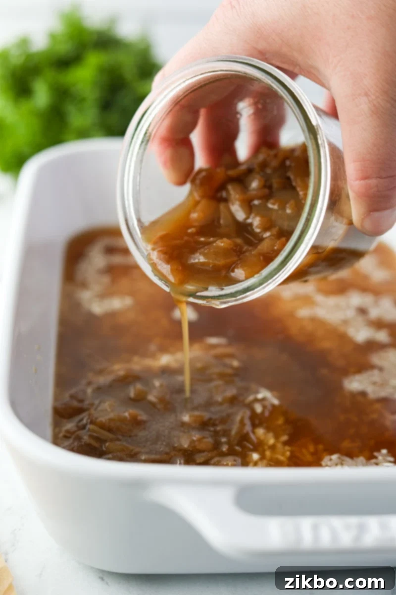 Golden Butter Rice 5 Pouring onion soup into a baking dish.