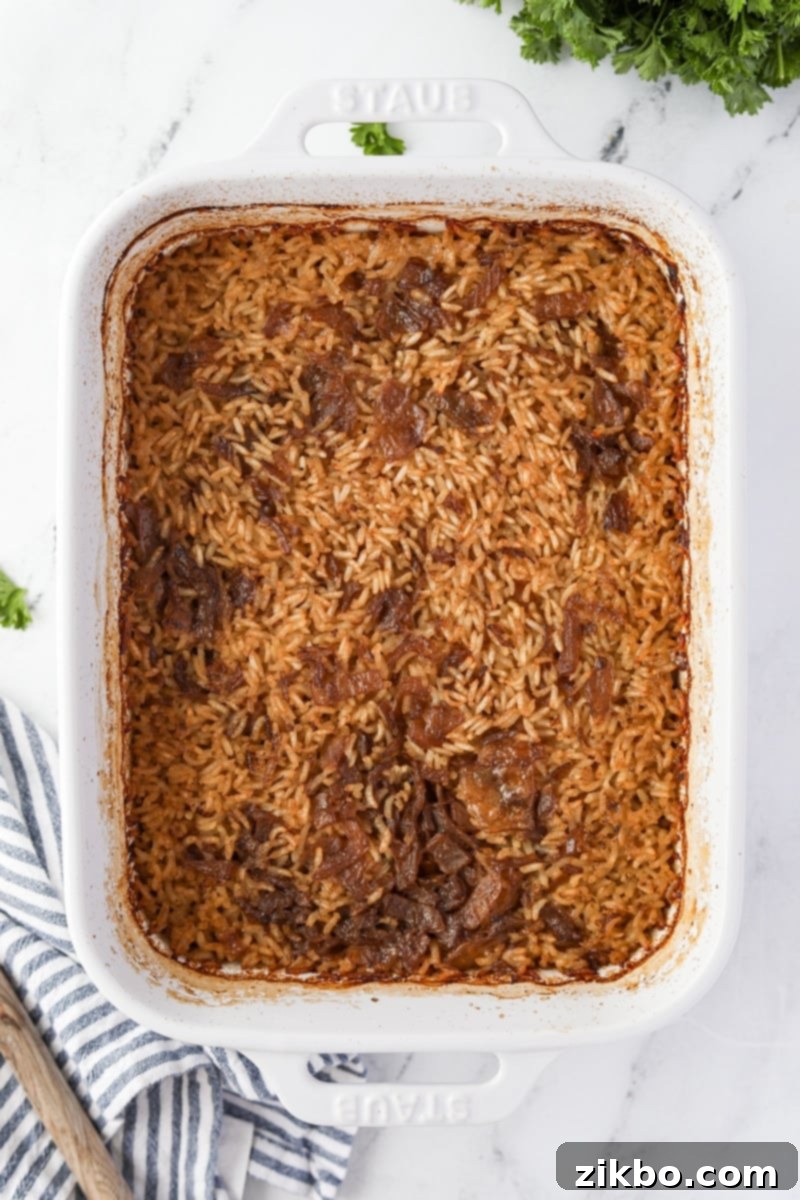 Golden Butter Rice 8 A baking dish filled with cooked rice and onions.