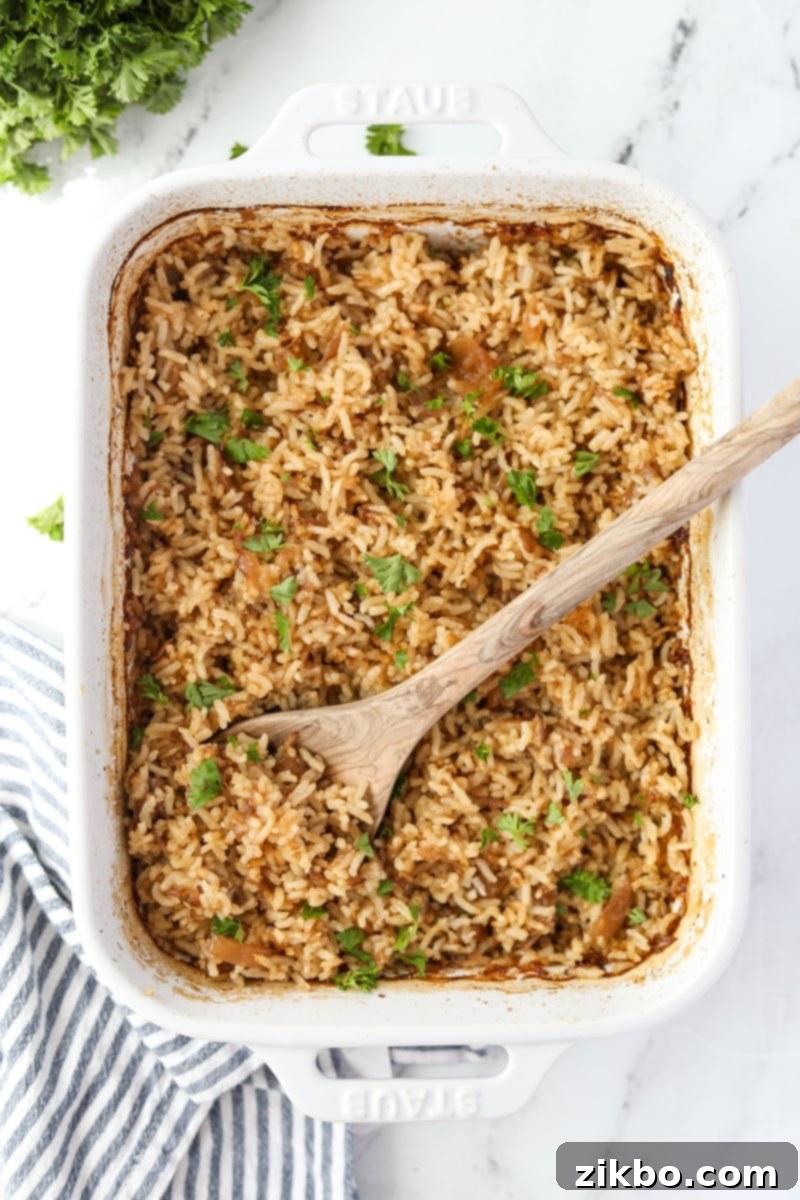 Golden Butter Rice 9 A baking dish filled with rice and garnished with parsley.