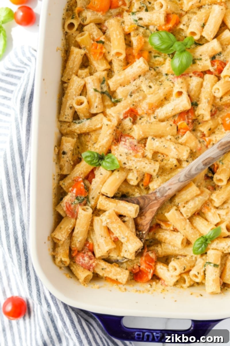 An overhead shot of a baking dish overflowing with creamy Boursin pasta, showcasing its appetizing texture and a hint of a golden crust.