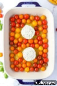 A baking dish filled with cherry tomatoes and Boursin cheese placed in the center.