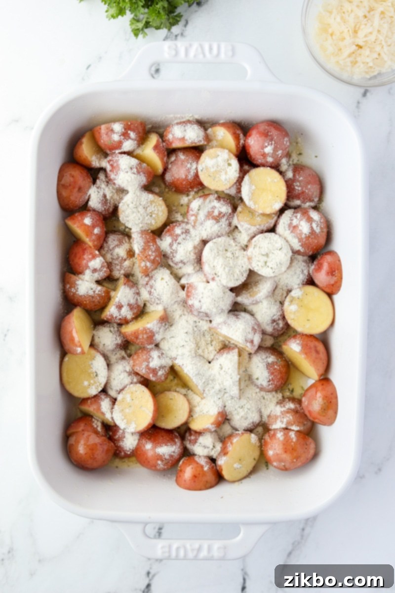 A baking dish with potatoes covered in ranch seasoning.