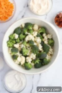 A large bowl with broccoli and cauliflower florets.