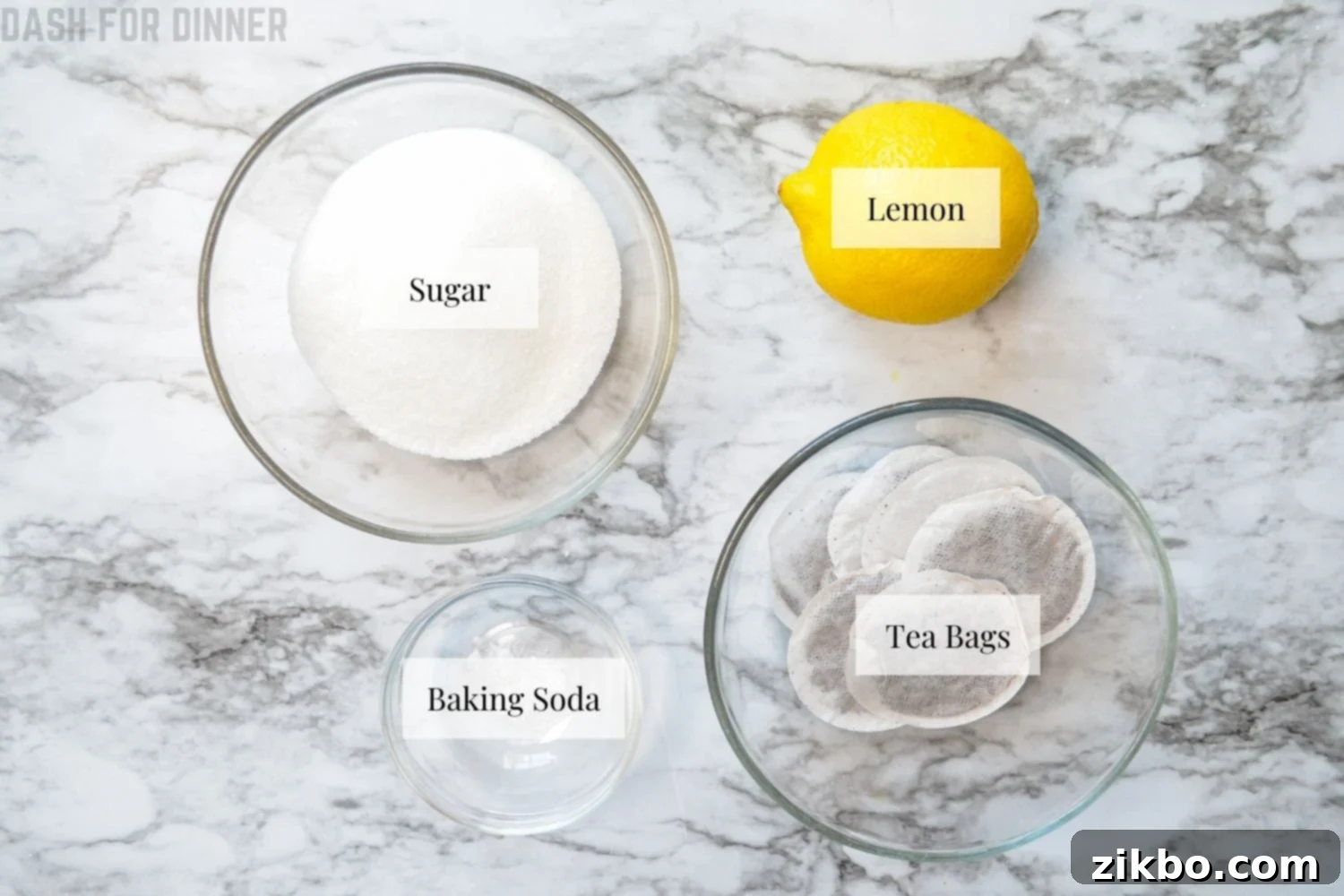 Instant Pot Iced Tea Crystal Clear and Smooth 3 A selection of ingredients for Instant Pot Iced Tea: tea bags, sugar, baking soda, and lemons.