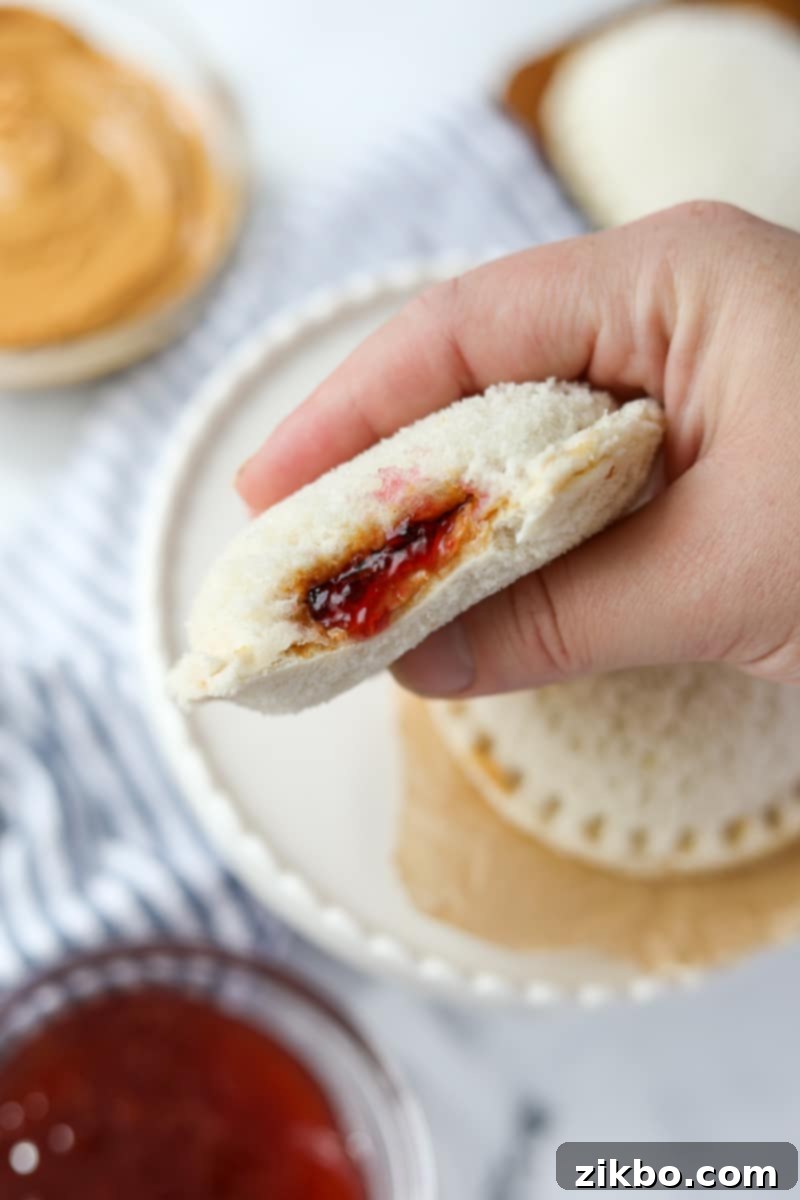 Squishing a pb&j sandwich in between a hand.