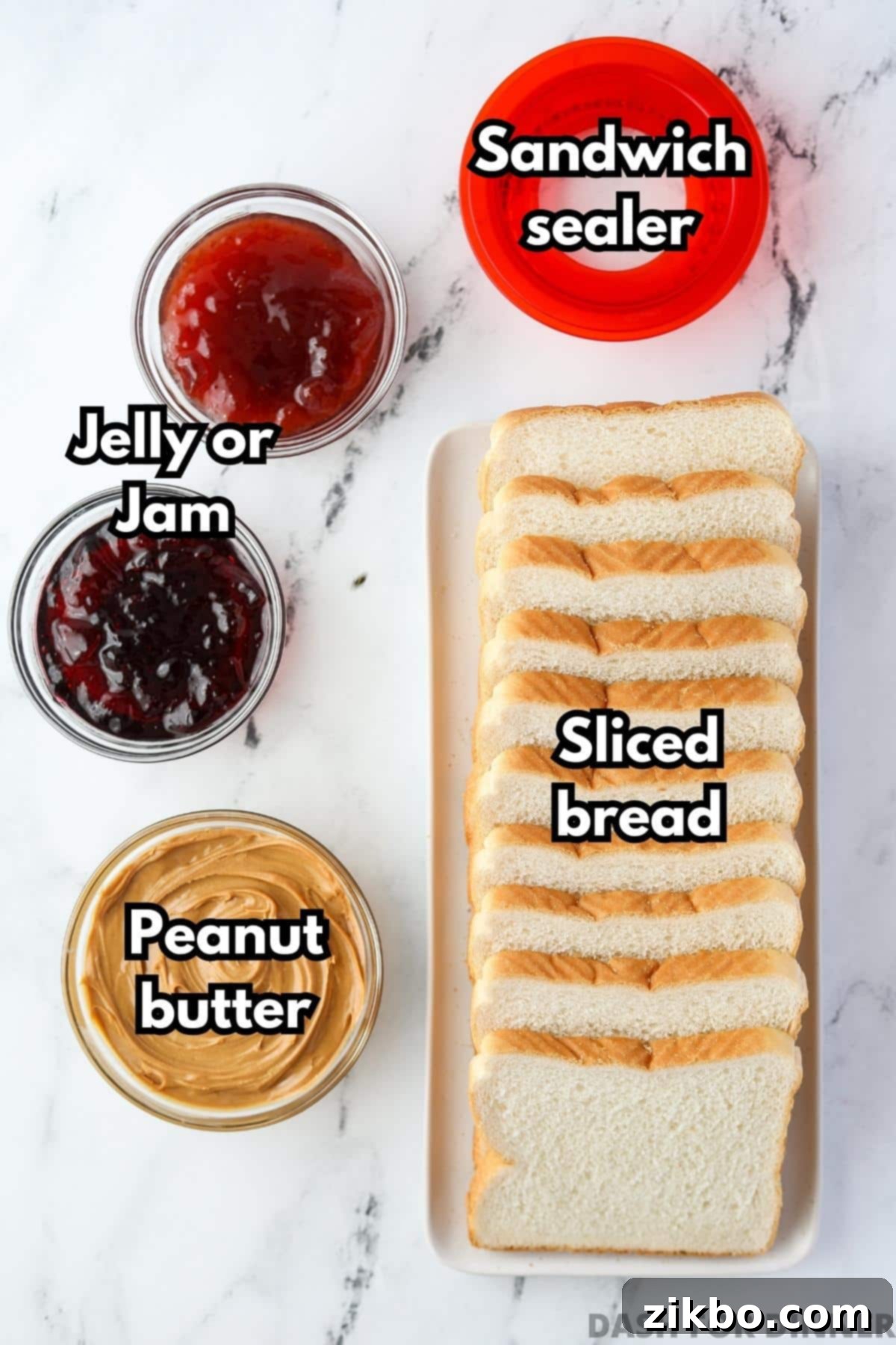 A loaf of bread, with small bowls of peanut butter, jelly, and jam on the side.