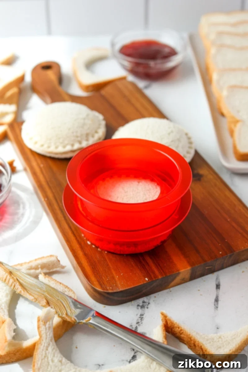 Using a sandwich sealer to press two sides of a sandwich together.