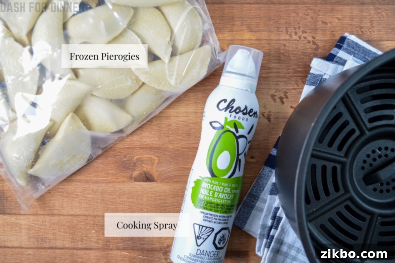 The simple ingredients needed to make crispy air fryer frozen pierogies, including a bag of pierogies and cooking spray.