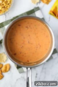 A saucepan with Rotel dip melted inside.