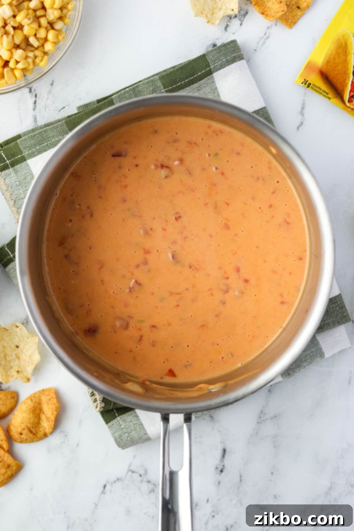 Zesty Southwest Delight 5 A saucepan showing melted Velveeta and Rotel dip, stirred until smooth.