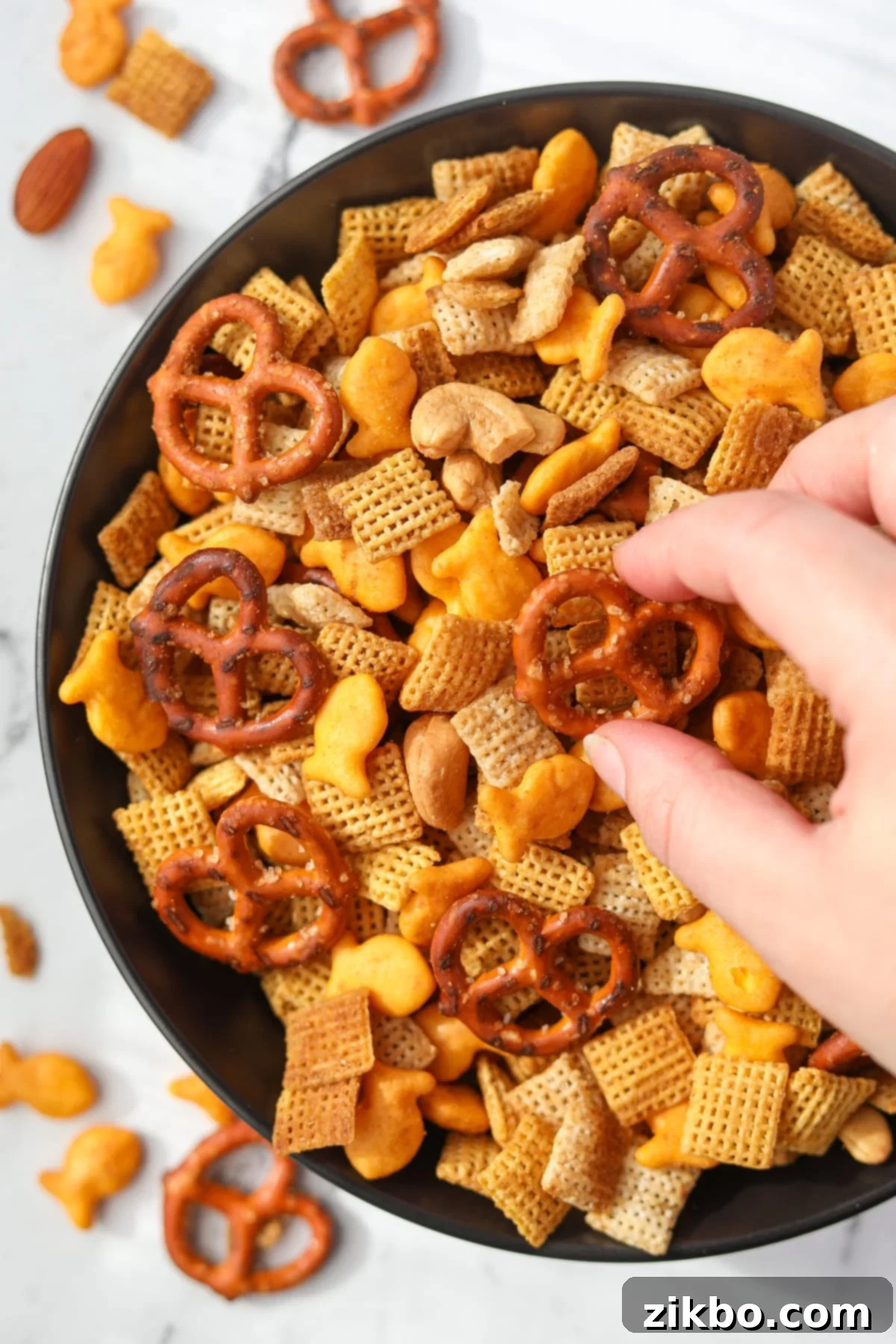 A snack bowl filled with homemade chex mix.