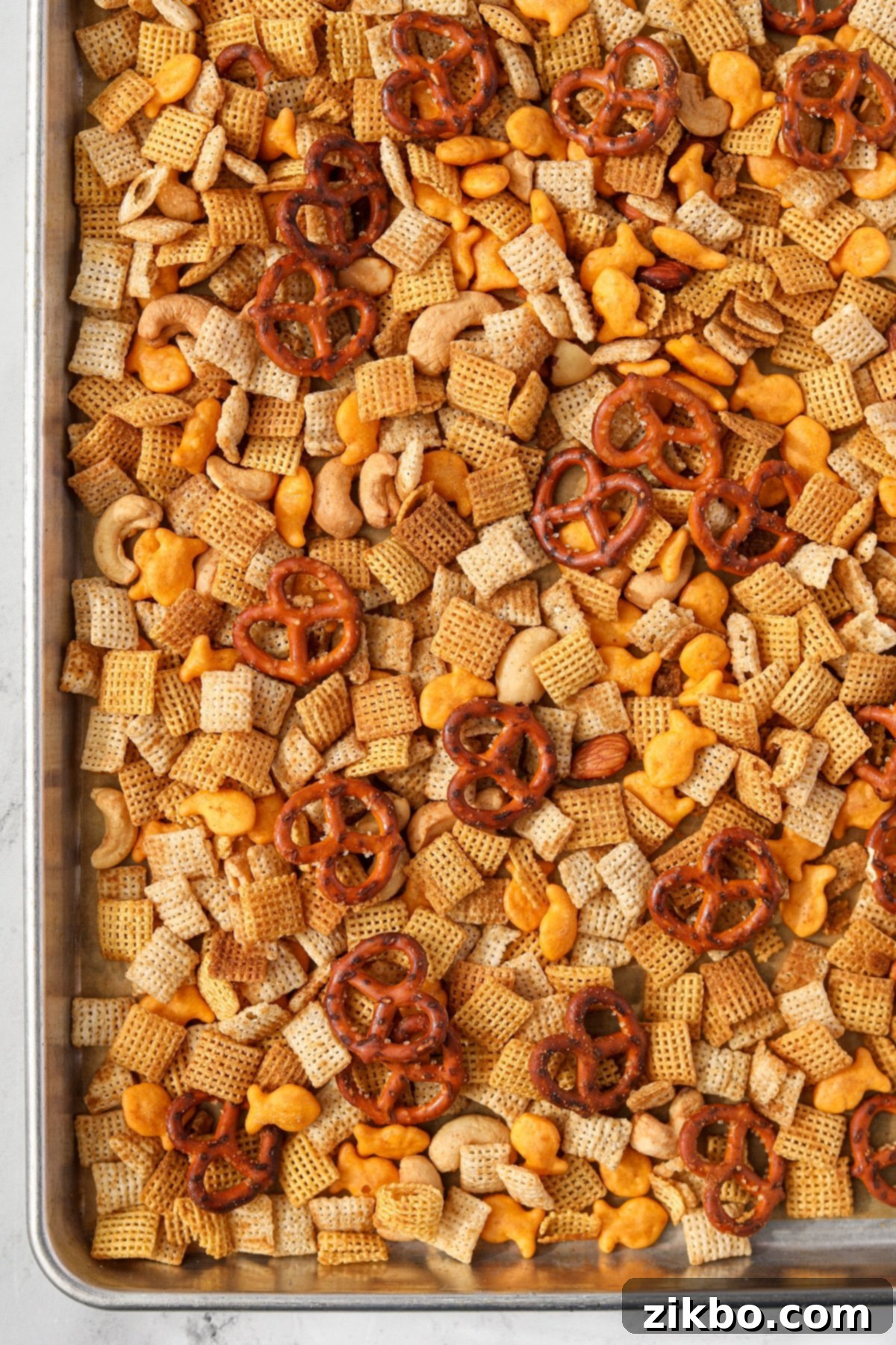 A baking sheet filled with Chex Mix.