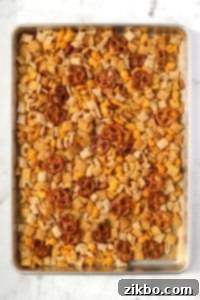 A baking pan with homemade snack mix on it.