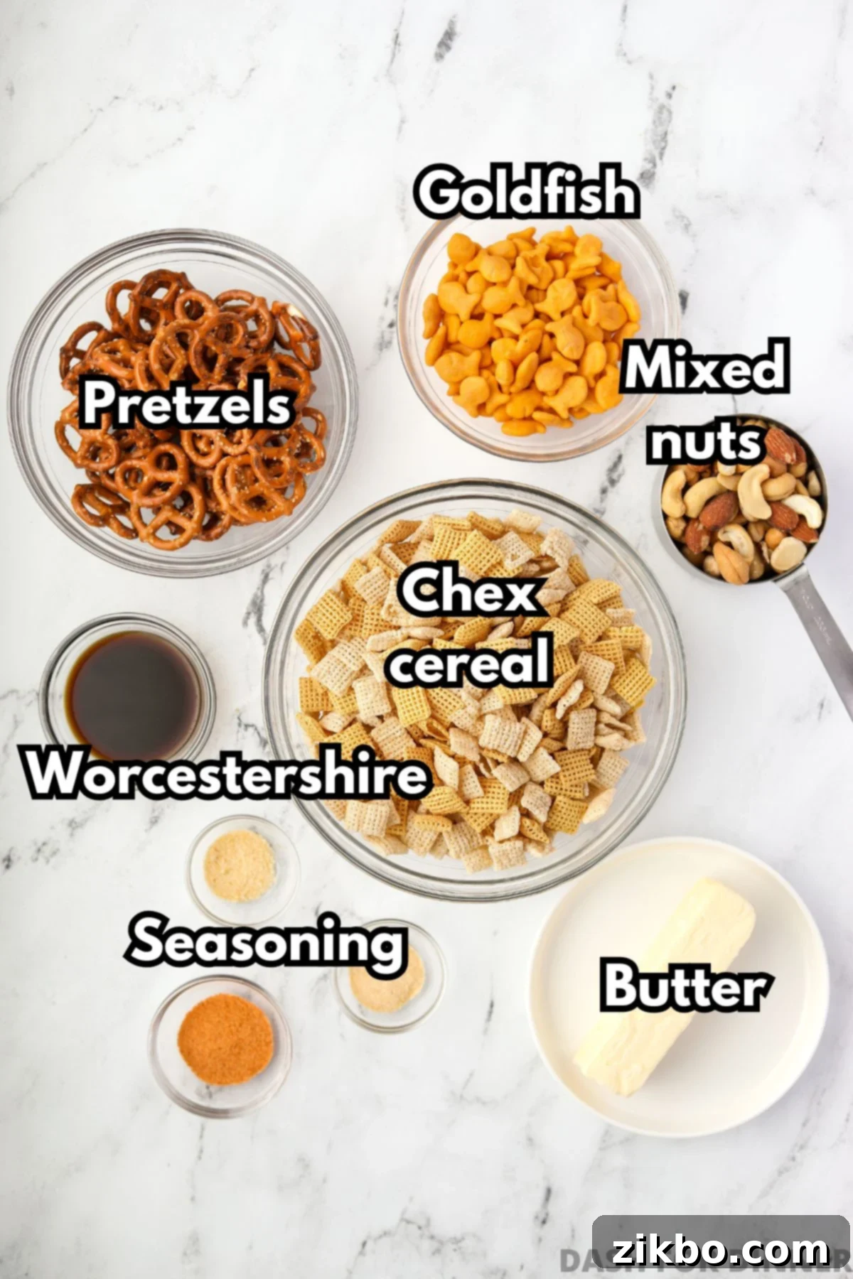 The ingredients needed to make snack mix: cereal, butter, pretzels, crackers, and nuts.